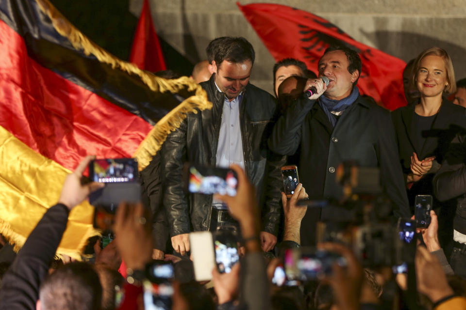 Albin Kurti, second right, leader of Self-Determination Movement (Vetevendosje), addresses a celebrating crowd gathered after winning the parliamentary elections in Kosovo capital Pristina early Monday, Oct. 7, 2019. Two Kosovo opposition parties emerged as the top-vote getters in Sunday's snap election of a new parliament held amid calls for leaders to resume dialogue with Serbia over normalizing ties. Self-Determination supporters took to the streets to celebrate. (AP Photo/Visar Kryeziu)