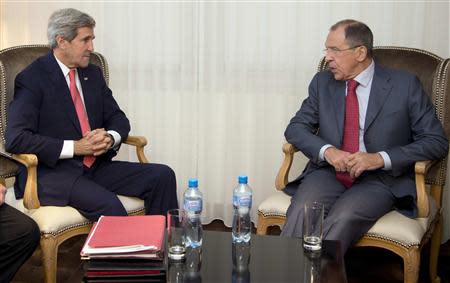 U.S. Secretary of State John Kerry (L) and Russia's Foreign Minister Sergei Lavrov sit together during a photo opportunity during a meeting, in Geneva November 23, 2013. REUTERS/Carolyn Kaster/Pool