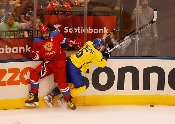 TORONTO, ON - SEPTEMBER 18: Anton Stralman #6 of Team Sweden takes a third-period hit from Alex Ovechkin #8 of Team Russia during the World Cup of Hockey at the Air Canada Center on September 18, 2016 in Toronto, Canada. Team Sweden won the game 2-1. (Photo by Gregory Shamus/Getty Images)