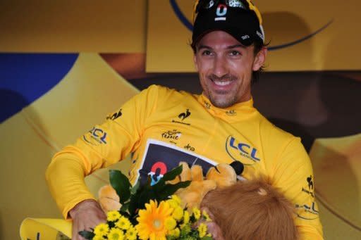 Switzerland's Fabian Cancellara celebrates after winning the 6.4 km individual time-trial and prologue in Liege. Cancellara of Switzerland won the race-opening prologue of the Tour de France here Saturday to claim the first race leader's yellow jersey of the 99th edition