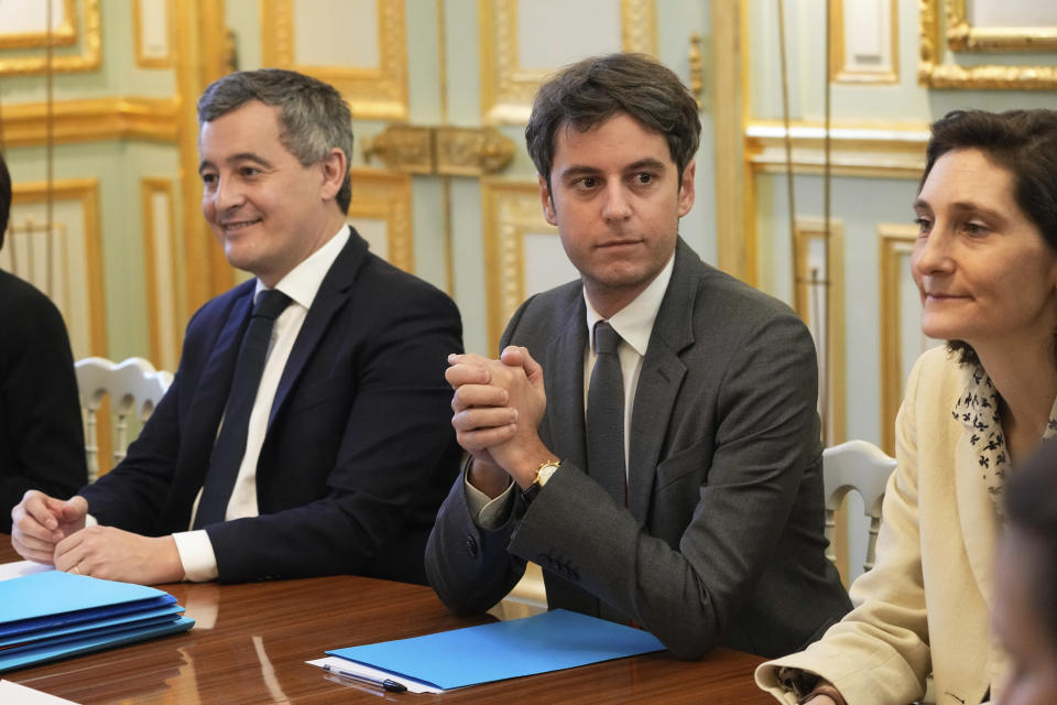 French Interior Minister Gérald Darmanin, left, new French prime minister Gabriel Attal, center, and newly appointed French Minister of Education, Sports, and Olympic Games, Amelie Oudea-Castera, right, attend the weekly cabinet meeting after a cabinet reshuffle, Friday, Jan. 12, 2024 at the Elysee Palace in Paris. (AP Photo/Michel Euler, Pool)