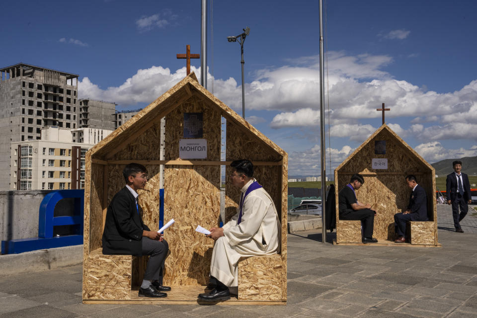 Faithfulls confess prior to the Holy Mass at the Steppe Arena in Ulaanbaatar, Mongolia on Sunday, Sept. 3, 2023. (AP Photo/Louise Delmotte)