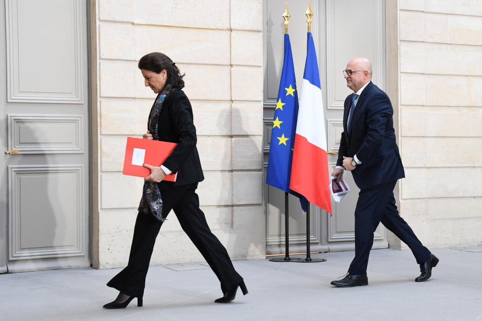 French Health and Solidarity Minister Agnes Buzyn, left, and French High Commissioner for Pension Reform Laurent Pietraszewski leave after a press conference at the Elysee Palace after a weekly cabinet meeting and an official presentation of the pension overhaul reform, Friday, Jan.24, 2020 in Paris. French unions are holding last-ditch strikes and protests around the country Friday as the government unveils a divisive bill redesigning the national retirement system. ( Alain Jocard/Pool via AP)