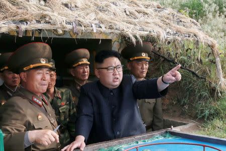 FILE PHOTO: North Korean leader Kim Jong Un inspects the defence detachment on Jangjae Islet and the Hero Defence Detachment on Mu Islet located in the southernmost part of the waters off the southwest front, in this undated photo released by North Korea's Korean Central News Agency (KCNA) on May 5, 2017. KCNA/Handout via REUTERS/File Photo