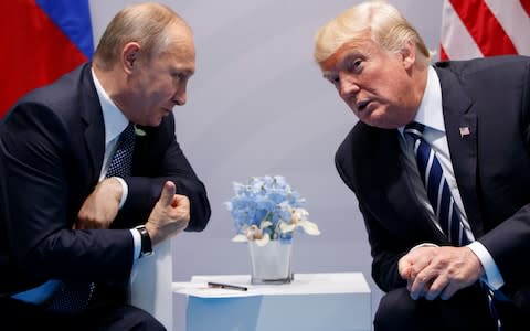 Donald Trump, right, and Vladimir Putin at the G-20 Summit on July 7, 2017, in Hamburg - Credit: AP Photo/Evan Vucci