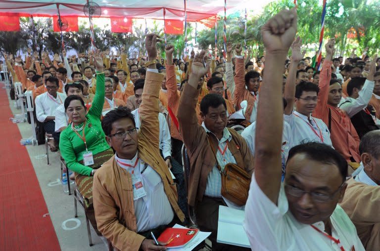 Delegates of the National League for Democracy gesture to vote during their first ever party conference at the Royal Rose Hall in Yangon on March 9, 2013. Aung San Suu Kyi's opposition wraps up its historic first congress Sunday, finalising its leadership line-up as it faces infighting that has overshadowed the launch of its bid to rule Myanmar after 2015 polls