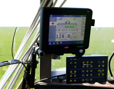 A screen placed in a tractor shows the output of liquid applied over a field in Irlbach near Deggendorf, Germany, April 21, 2016. REUTERS/Michaela Rehle