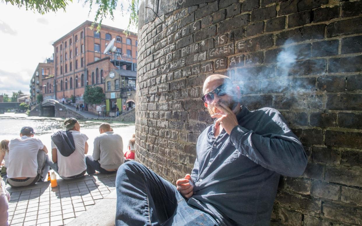 Cannabis user Adam McWilliam smokes a joint openly in Camden, north London - Paul Grover