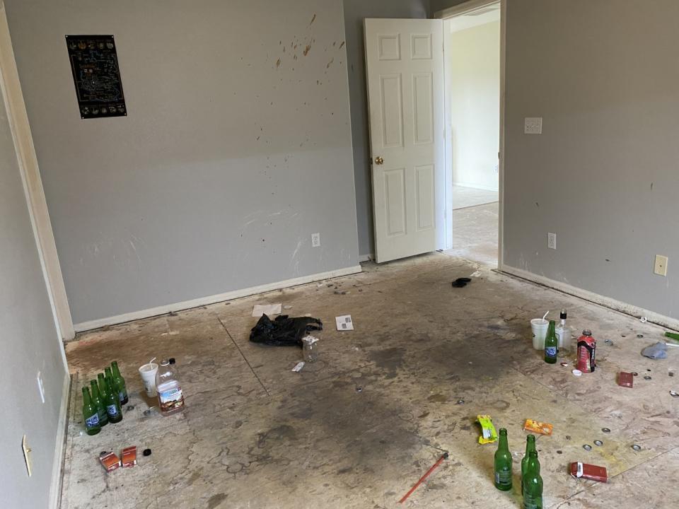 Pictured is the damaged home, with beer bottles and a sleeping mat on the floor. Source: News 5