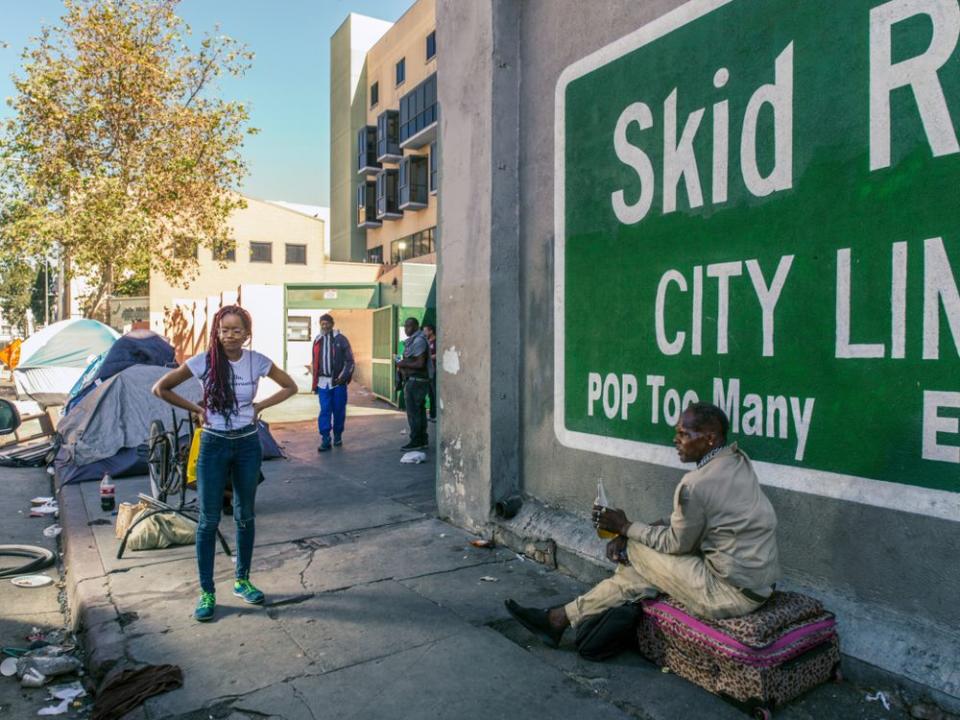 VonChaz (left) walks around L.A.’s Skid Row passing out period kits to people in need