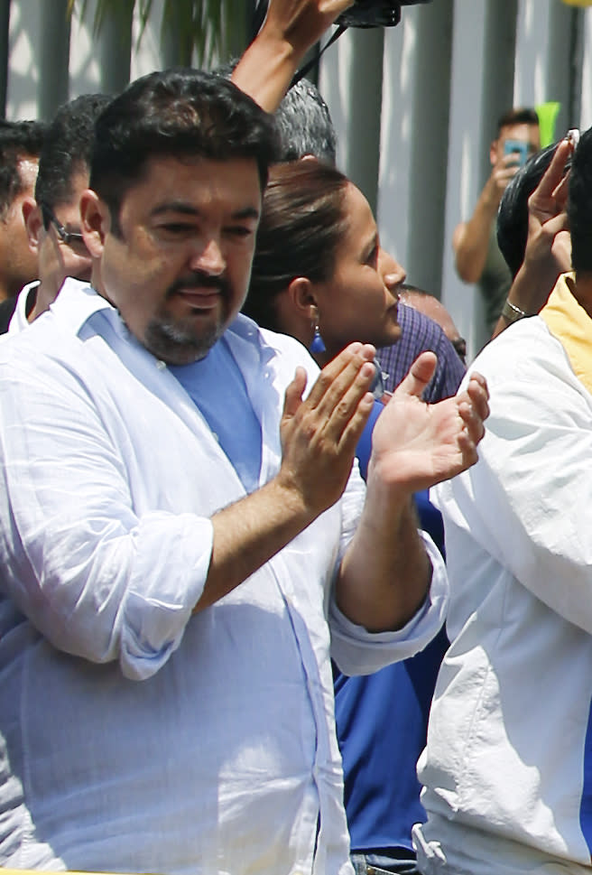 In this Saturday, March 16, 2019 photo, lawyer Roberto Marrero applauds upon his arrival to a rally of Venezuelan opposition leader Juan Guaido, who has declared himself interim president in Valencia, Venezuela. Venezuelan security forces detained Marrero, a key aide to Guaido in a raid on his home early Thursday, March 21 an opposition lawmaker said. Marrero was taken by intelligence agents in the overnight operation in Caracas. (AP Photo/Fernando Llano)