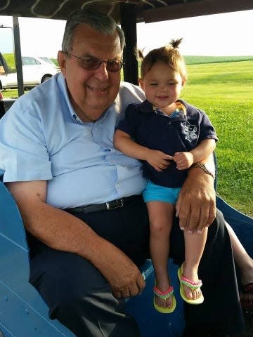 Dennis Voy with his great-grandchild, Cora, at Voy 61 in Delmar.