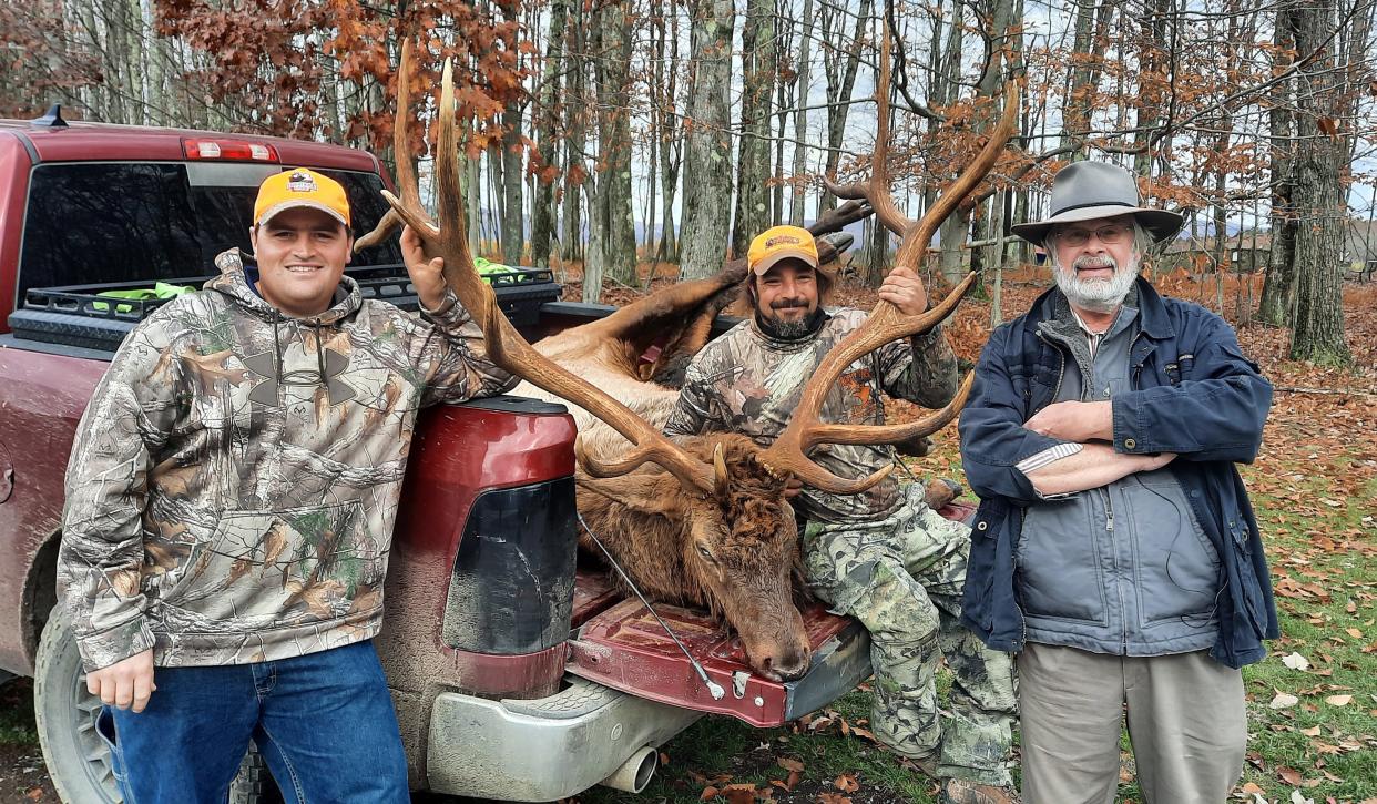 William Biggs, far right, shot an 8x6 bull elk Tuesday morning with the help of guides Paul Martin, left, and Josh Patton of Trophy Rack Lodge.