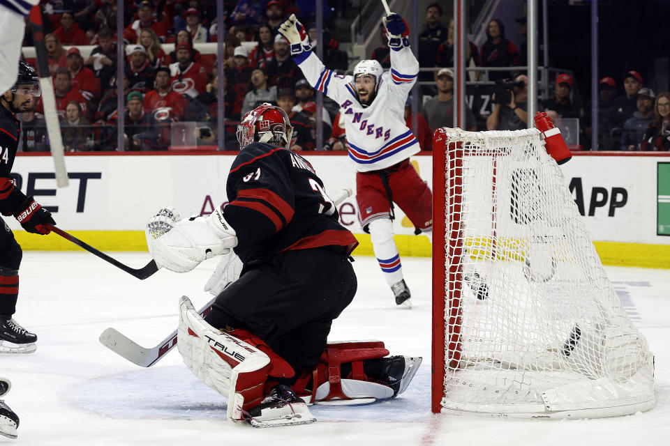 New York Rangers' Mika Zibanejad (93) celebrates a goal by Chris Kreider against Carolina Hurricanes goaltender Frederik Andersen during the third period in Game 6 of an NHL hockey Stanley Cup second-round playoff series in Raleigh, N.C., Thursday, May 16, 2024. (AP Photo/Karl B DeBlaker)