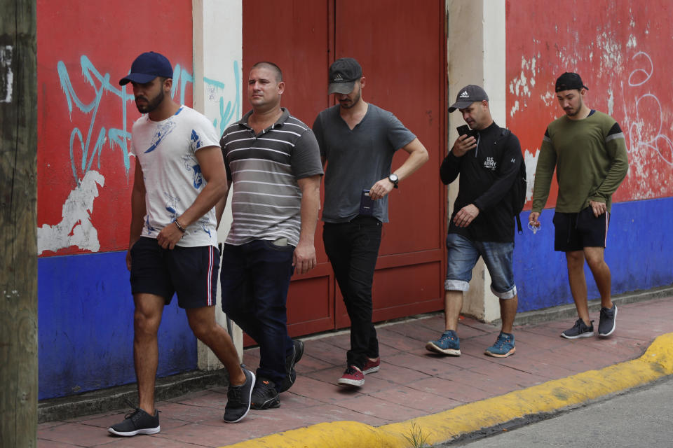 In this May 28, 2019 photo, Cuban migrants walk on the streets of Tapachula, Chiapas state, Mexico. The group says they were singled out by authorities as the ringleaders of the mass break out that happened in April, when more than 600 migrants escaped from the Siglo XXI detention center. (AP Photo/Marco Ugarte)