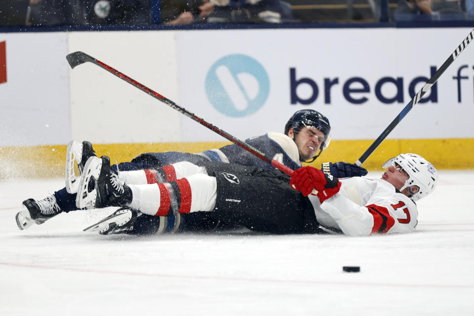 Columbus Blue Jackets forward Cole Sillinger, left, collides with New Jersey Devils defenseman Simon Nemec, right, during the second period an NHL hockey game in Columbus, Ohio, Saturday, Dec. 16, 2023. (AP Photo/Paul Vernon)