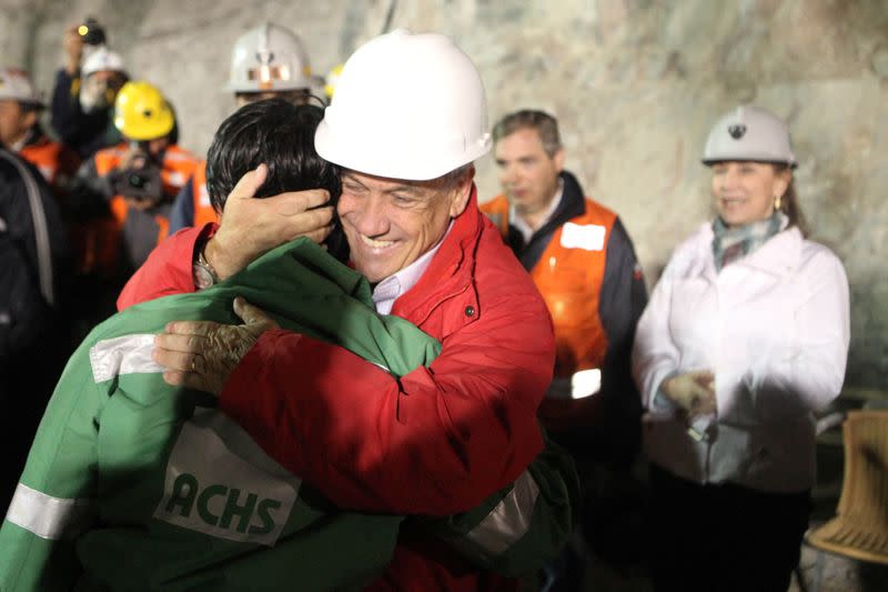 FILE PHOTO: Trapped miner Ticona is embraced by Chile's President Pinera after reaching the surface to become the 32nd to be rescued from the San Jose mine in Copiapo
