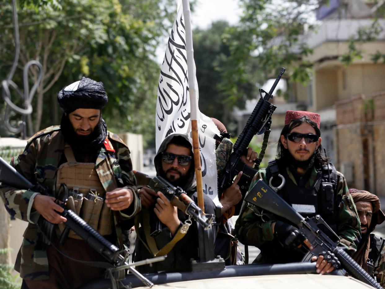 Taliban fighters display their flag on patrol in Kabul, Afghanistan, Thursday, Aug. 19, 2021.