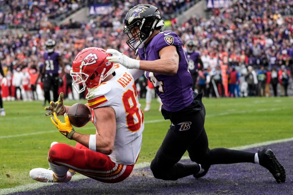 Kansas City Chiefs tight end Travis Kelce (87) makes a touchdown catch in the end zone against Baltimore Ravens safety Kyle Hamilton (14) during the first half of an AFC Championship NFL football game, Sunday, Jan. 28, 2024, in Baltimore. (AP Photo/Alex Brandon)
