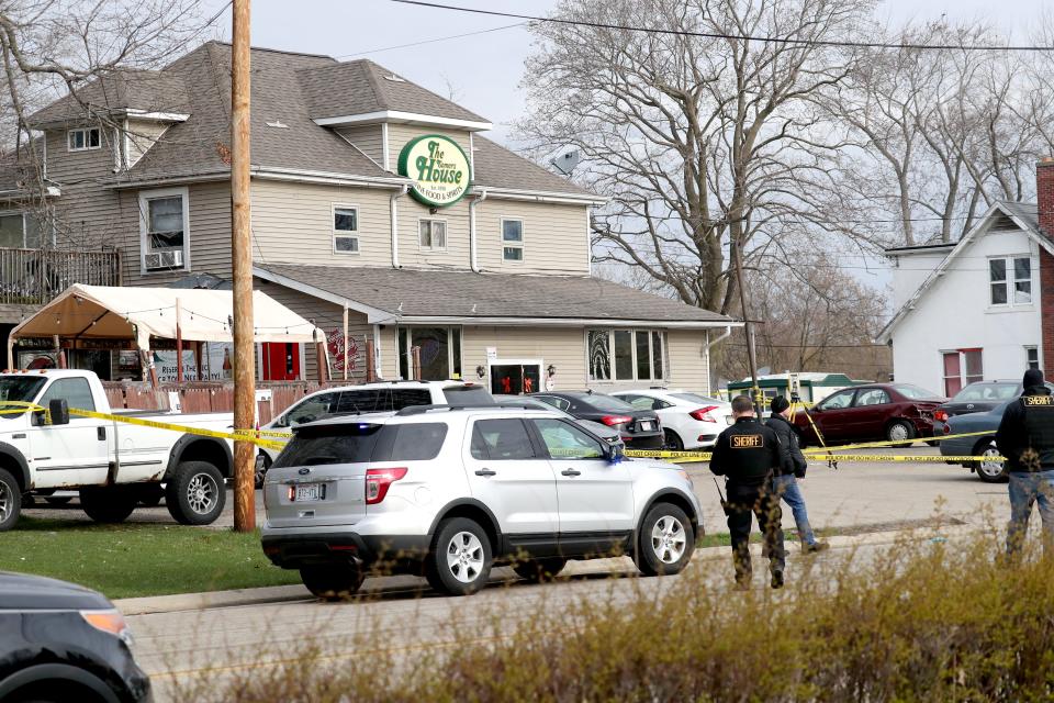 Officials investigate the scene where three people were killed and at least two were seriously injured in a shooting at The Somers House tavern at 1548 Sheridan Road in Kenosha County.