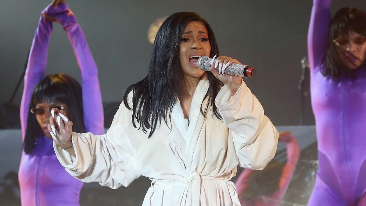 Cardi B's boobs almost pop out of her jacket as she wears a plunging pink  suit for a raunchy show in Florida