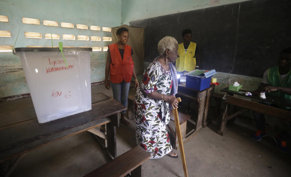 An elderly woman casts her ballot in the presidential election in Lome, Togo, Saturday, Feb. 22 2020. The West African nation of Togo is voting Saturday in a presidential election that is likely to see the incumbent re-elected for a fourth term despite years of calls by the opposition for new leadership. (AP Photo/Sunday Alamba)