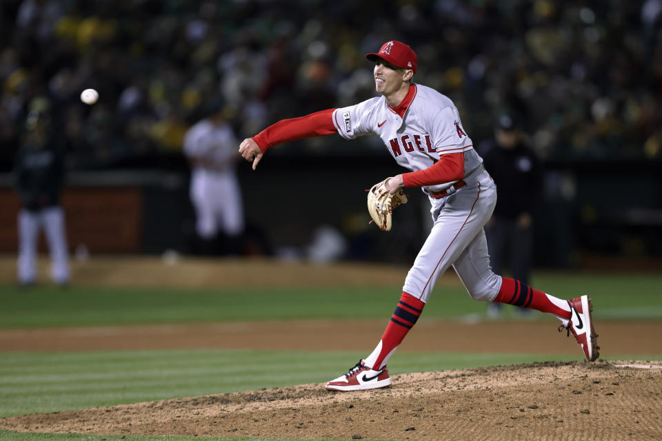 Los Angeles Angels relief pitcher Jimmy Herget throws against the Oakland Athletics during the seventh inning of an opening day baseball game in Oakland, Calif., Thursday, March 30, 2023. (AP Photo/Jed Jacobsohn)