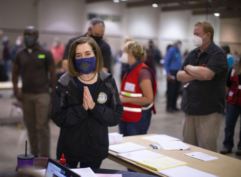 Oregon Governor Kate Brown toured the Oregon State Fairgrounds in Salem, Ore., Saturday afternoon, Sept. 12, 2020, where she spoke with volunteers and evacuees. Brown also toured the animal facility where evacuated animals are being kept. Fires along Oregon's Cascade Range grew Saturday, but at a slower rate than earlier in the week. (Beth Nakamura/The Oregonian via AP, Pool)