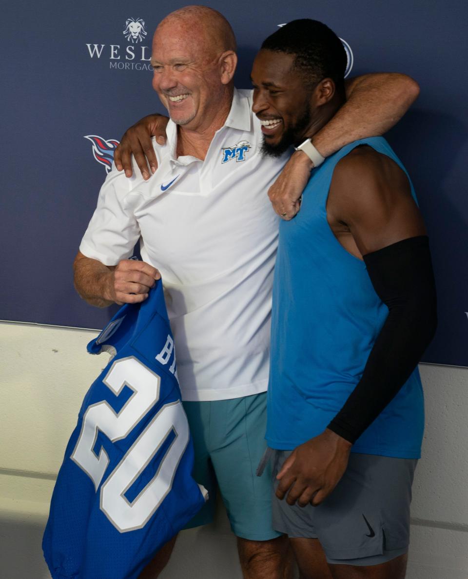 Middle Tennessee State University head football coach Rick Stockstill hugs Tennessee Titans free safety Kevin Byard as the announcement is made to retire Byard's college number at MTSU after a Titans practice at Ascension Saint Thomas Sports Park Thursday, Aug. 4, 2022, in Nashville, Tenn. 