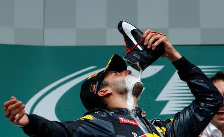 Germany Formula One - F1 - German Grand Prix 2016 - Hockenheimring, Germany - 31/7/16 - Red Bull Racing's Daniel Ricciardo drinks champagne from a shoe after the race. REUTERS/Ralph Orlowski