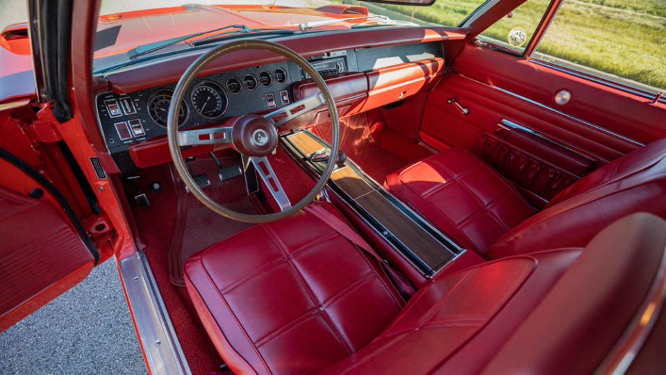 The red bucket-seat interior of a 1969 Dodge Charger Daytona.