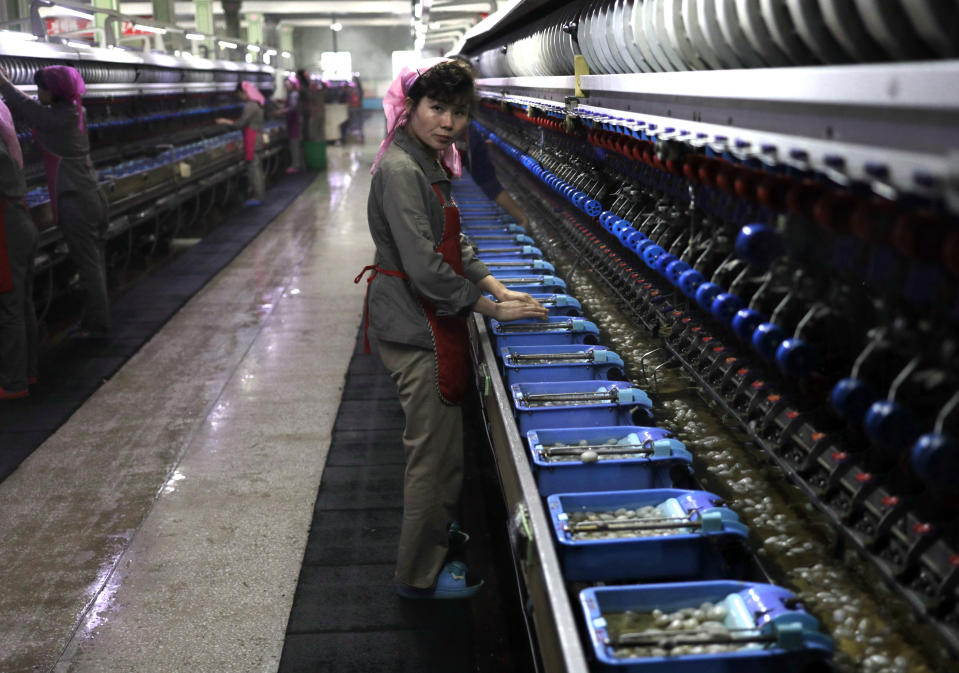 A woman works at the Kim Jong Suk silk mill in Pyongyang, North Korea, Tuesday, Nov. 26, 2019. The silk mill, named after North Korean leader Kim Jong Un's grandmother, is where more than a thousand workers – mostly women – sort and process silkworms to produce silk thread. (AP Photo/Dita Alangkara)