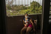 Ana Laura Ramirez Lavandero, 10, poses or a portrait holding drumsticks on the balcony of her home in Havana, Cuba, on Friday, May 8, 2020. Ana Laura dreams of becoming a famous drummer. This was her first year at a highly selective institute for students identified early on as musically talented. She is continuing with classes in math, history and Spanish, but not music, during the COVID-19 coronavirus lockdown. (AP Photo/Ramon Espinosa)