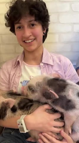 <p>Jennifer Lopez/Instagram</p> Emme holding piglets