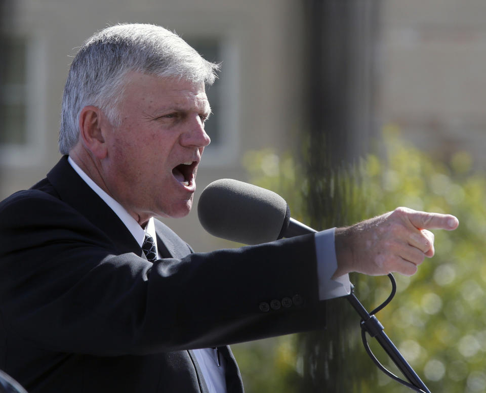 FILE - In this Oct. 12, 2016 file photo, Franklin Graham, president and CEO of the Billy Graham Evangelistic Association, addresses a crowd gathered in front of the Virginia State Capitol with his "Decision 2016" tour. The evangelist Graham recently asked thousands of people at an Oregon rally to pray for the state's Democratic governor, saying she should be a Christian. Yoga and meditation suit Gov. Kate Brown just fine, she told reporters Thursday, Aug. 9, 2018, when asked if she follows a certain faith. (Bob Brown/Richmond Times-Dispatch via AP)