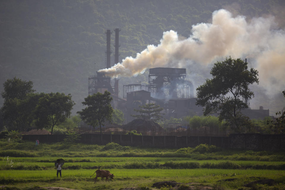 Smoke rises from a coal-powered steel plant at Hehal village near Ranchi, in eastern state of Jharkhand, Sunday, Sept. 26, 2021. No country will see energy needs grow faster in coming decades than India, and even under the most optimistic projections part of that demand will have to be met with dirty coal power — a key source of heat-trapping carbon emissions. (AP Photo/Altaf Qadri)