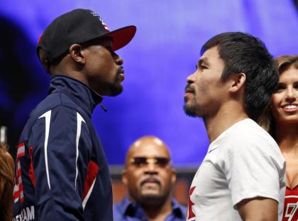 Floyd Mayweather Jr. and Manny Pacquiao pose during their weigh-in on Friday. (AP)