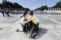 A veteran tours the World War Two Memorial in Washington October 1, 2013. Despite the U.S. government shutdown affecting the site, a barricade was removed to give veterans access to the memorial. Up to one million federal workers were thrown temporarily out of work on Tuesday as the U.S. government partially shut down for the first time in 17 years in a standoff between President Barack Obama and congressional Republicans over healthcare reforms. REUTERS/Kevin Lamarque (UNITED STATES - Tags: POLITICS BUSINESS)