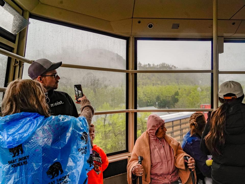 People take photos from the tram