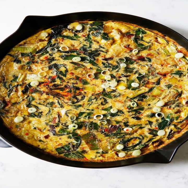 A leek and chard frittata in a cast-iron skillet