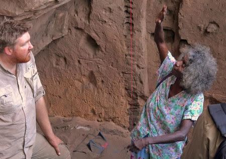 A supplied image shows Chris Clarkson talking with Madjedbebe site custodian May Nango during excavations at the Madjedbebe site located in the Kakadu region in northern Australia June 20, 2015 which has revelead that humans reached the country at least 65,000 years ago - up to 18,000 years earlier than archaeologists previously thought. Dominic O'Brien-Gundjeihmi Aboriginal Corporation/Handout via REUTERS