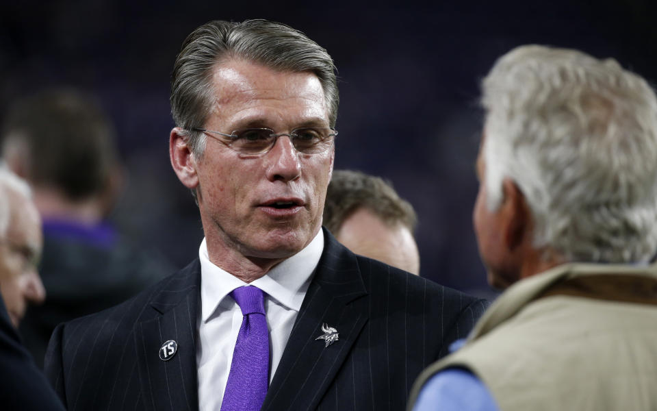 FILE - In this Oct. 28, 2018, file photo, Minnesota Vikings general manager Rick Spielman, left, stands on the field before an NFL football game against the New Orleans Saints in Minneapolis. Vikings President Mark Wilf issued a statement of confidence in Spielman and head coach Mike Zimmer on Friday, Jan. 3, 2020, tamping down speculation about their future two days prior to the team's playoff game. (AP Photo/Bruce Kluckhohn, File)