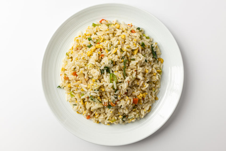 fried rice with vegetables on white plate