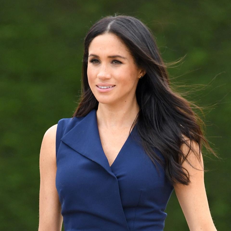 Meghan Markle stepped out inin a form-fitting dress that hugged her baby bump—and revealed a flash of bare leg—in Australia.