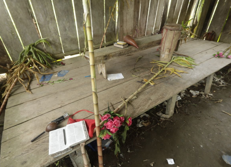 Bibles, flowers, a drum and a microphone are seen inside the improvised temple.