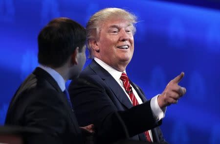 Republican U.S. presidential candidate Senator Marco Rubio (L) talks to businessman Donald Trump at the end of the 2016 U.S. Republican presidential candidates debate held by CNBC in Boulder, Colorado, October 28, 2015. REUTERS/Rick Wilking