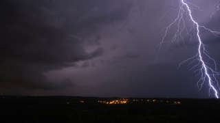 A photograph shows a thunderstorm above the village of Montaud, southern France, on August 16, 2022. - Eight departments in France are placed on orange alert on the Mediterranean arc on August 16, 2022. (Photo by NICOLAS TUCAT / AFP)