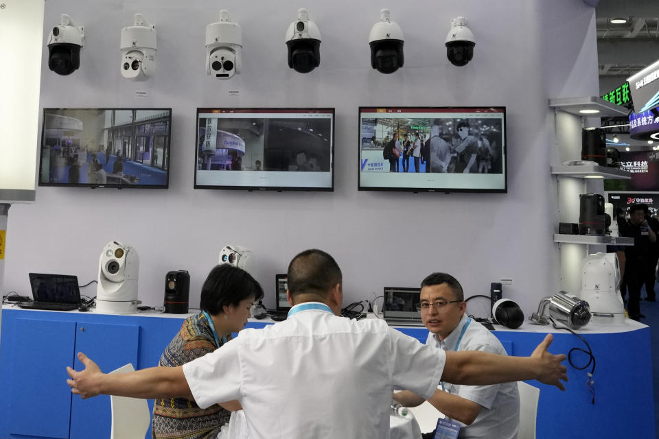 Vendors promoting surveillance technology chat during the Security China 2023 in Beijing, on June 7, 2023. After years of breakneck growth, China's security and surveillance industry is now focused on shoring up its vulnerabilities to the United States and other outside actors, worried about risks posed by hackers, advances in artificial intelligence and pressure from rival governments. The renewed emphasis on self-reliance, combating fraud and hardening systems against hacking was on display at the recent Security China exhibition in Beijing. (AP Photo/Ng Han Guan)