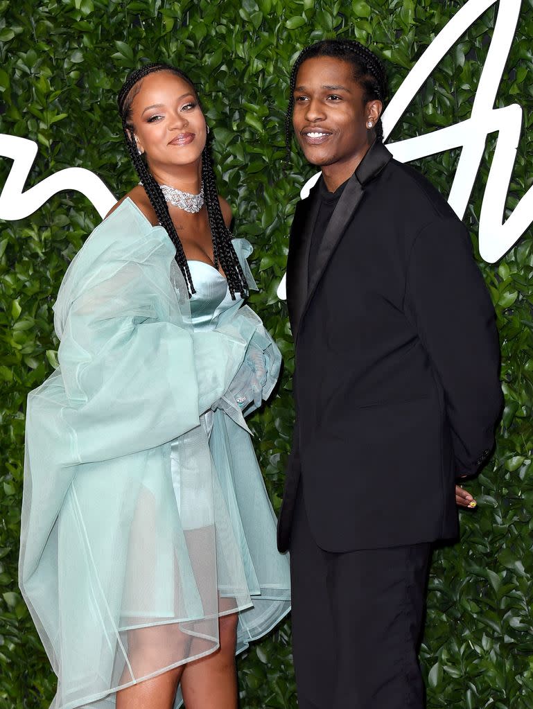 Rihanna and ASAP Rocky smiling at a red carpet event