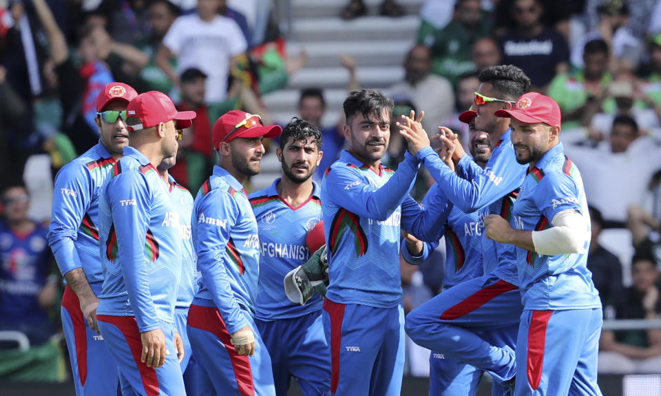 Afghanistan's Rashid Khan, center right, celebrates with teammates after the dismissal of Pakistan's Haris Sohail during the Cricket World Cup match between Pakistan and Afghanistan at Headingley in Leeds, England, Saturday, June 29, 2019. (AP Photo/Rui Vieira)
